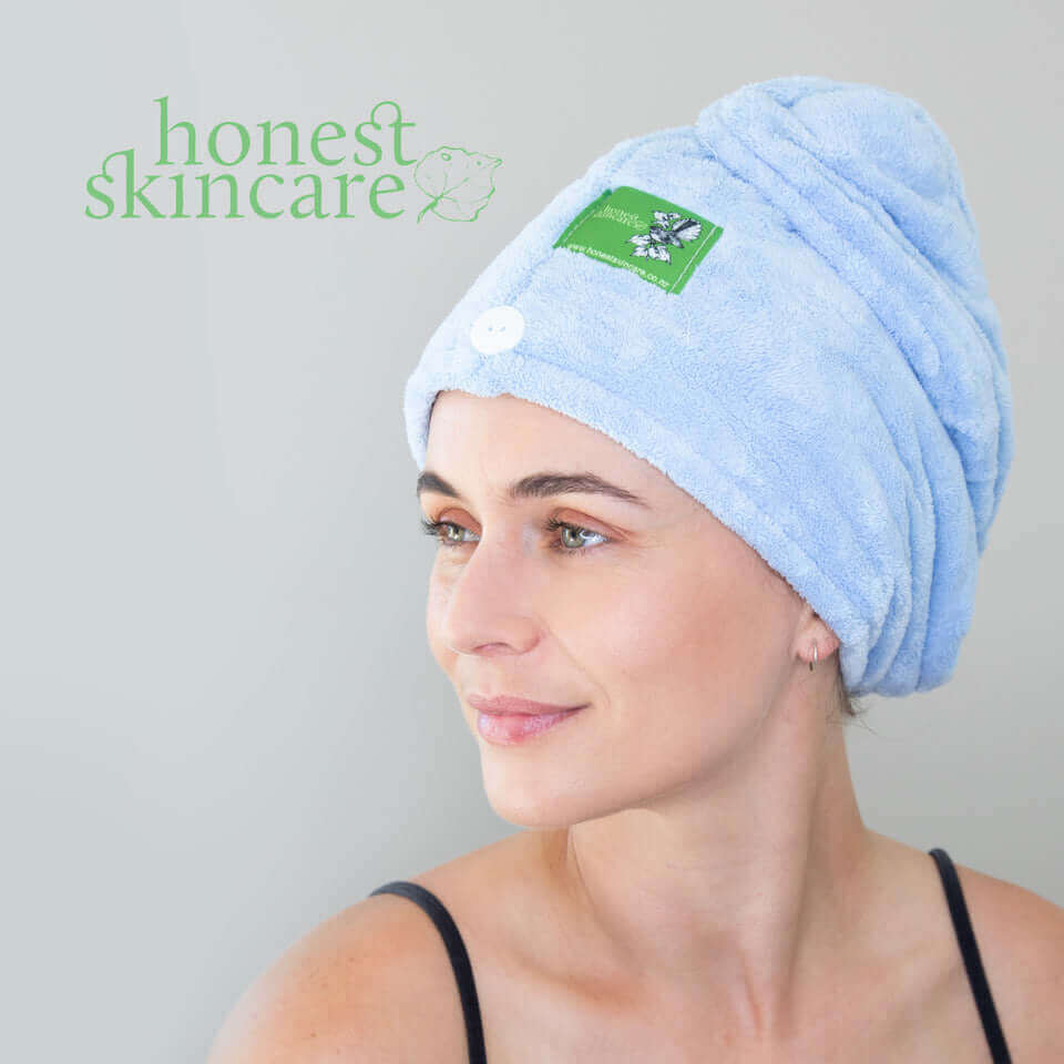 Woman wearing a castor oil hair wrap, promoting hair care and moisture benefits.
