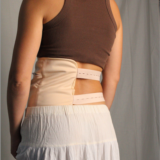 Back view of a woman wearing a Castor Oil Body Wrap for Waist and Back, showcasing its comfortable fit and design.
