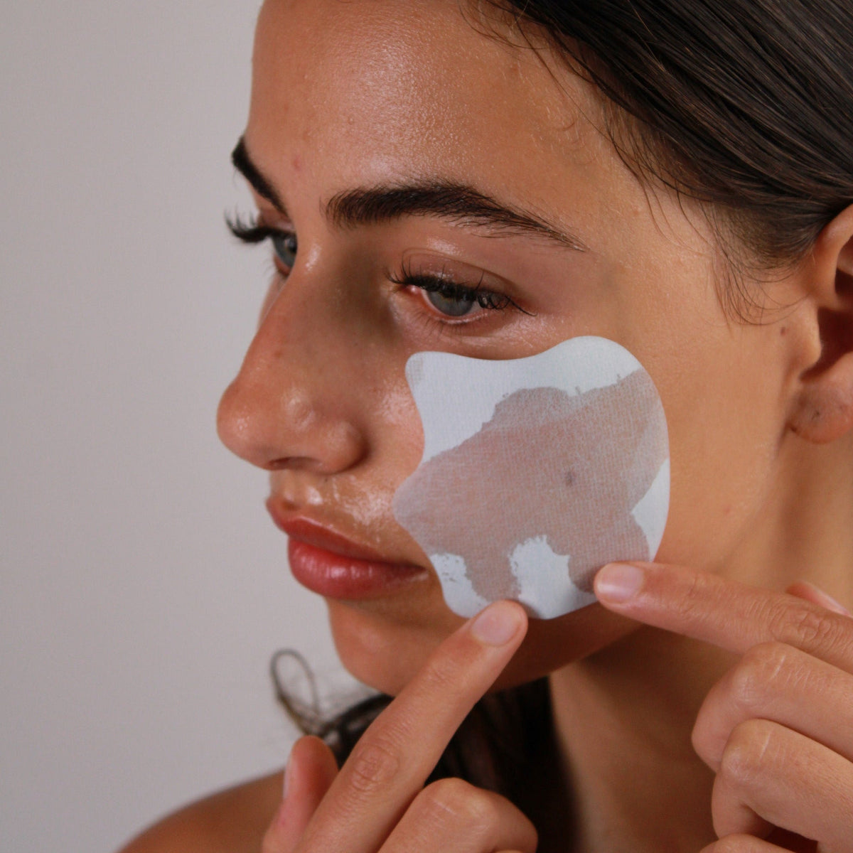 woman applying honest skincare best collagen mask to skin