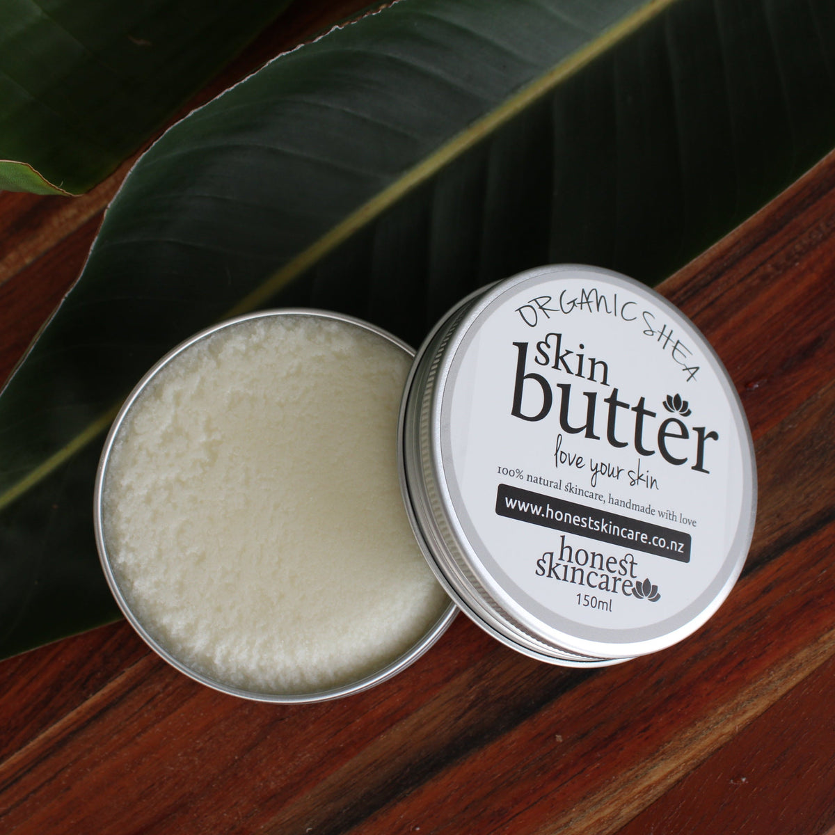Shea butter body cream in a tin, promoting natural skin nourishment and hydration.
