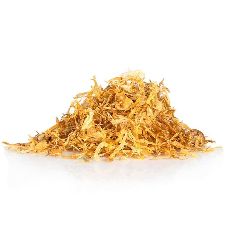Dried calendula petals in a pile, showcasing their natural yellow color and organic quality for skincare use.