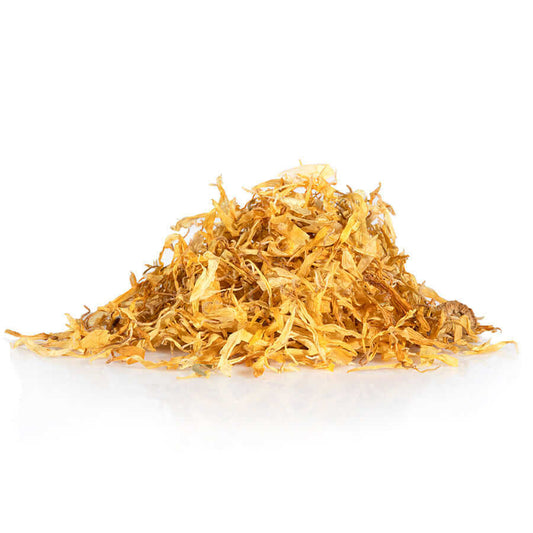 Dried calendula petals in a pile, showcasing their natural yellow color and organic quality for skincare use.