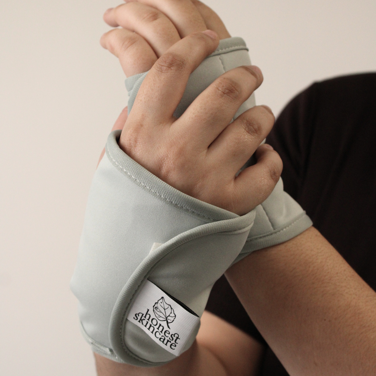 Hand and Wrist Wraps (Pair) on hands for use with Honest Skincare Organic Castor Oil