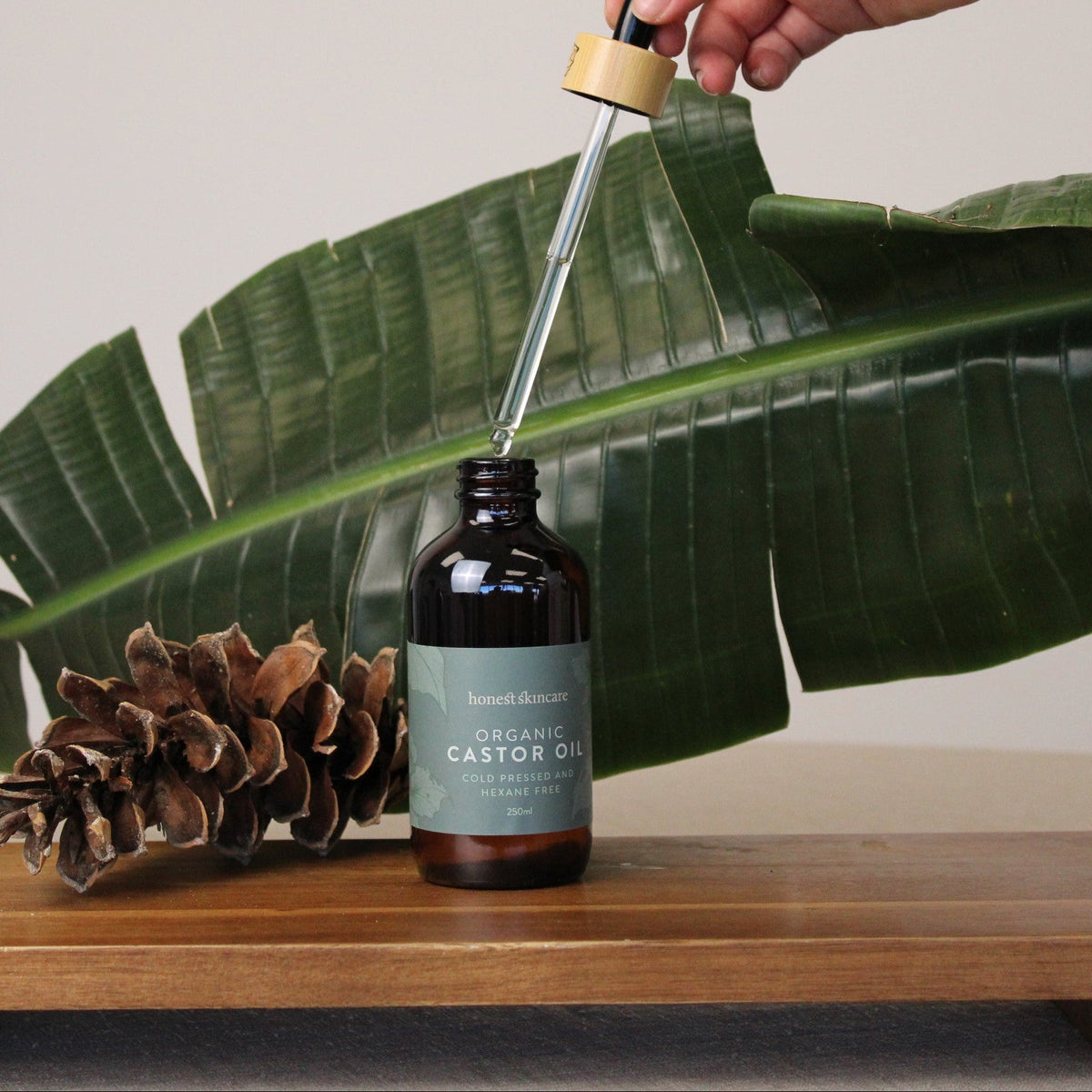 Organic Castor Oil in glass bottle with dropper, highlighting its natural and nourishing properties.