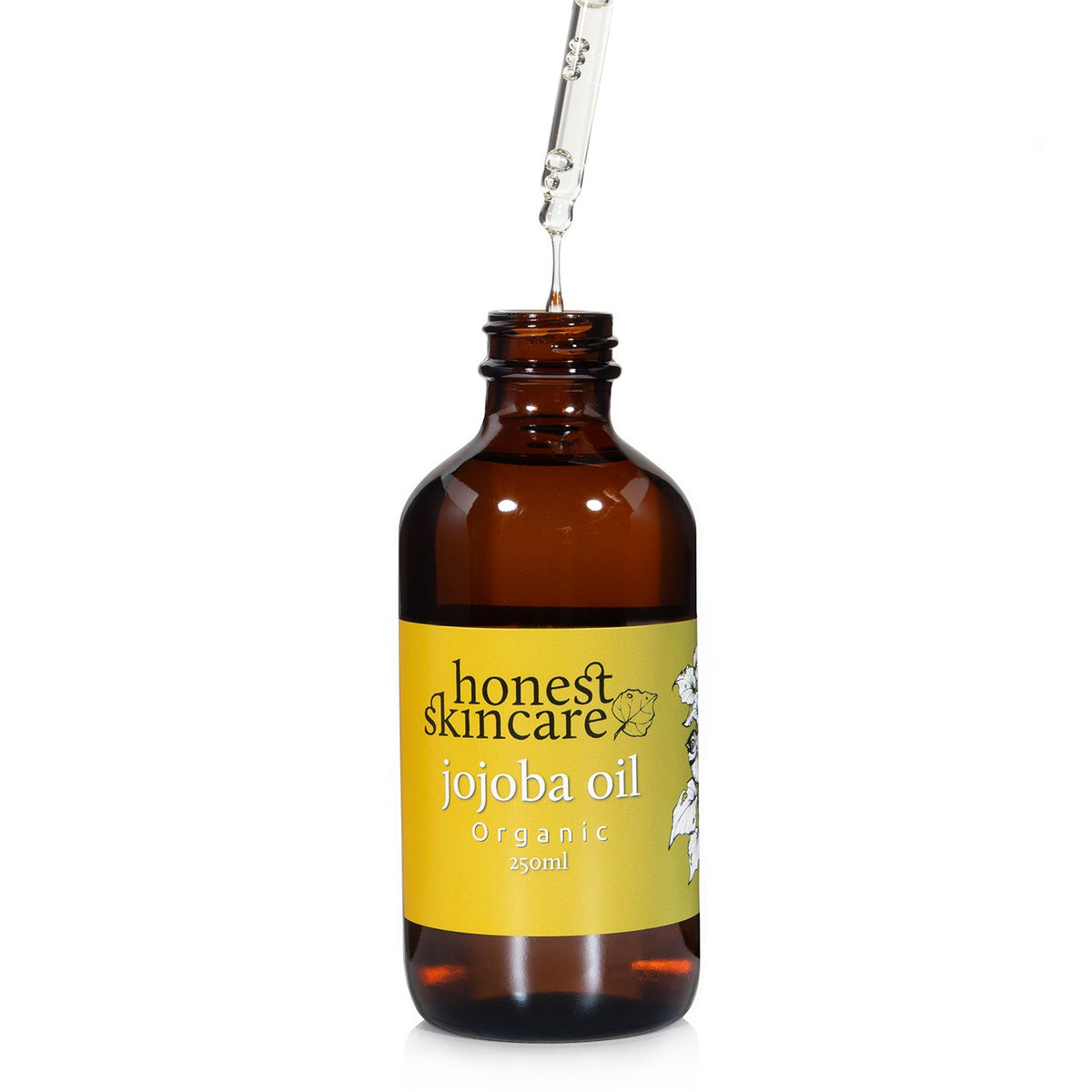 Jojoba Oil for Skin in an amber bottle, dropper releasing organic oil for moisturizing benefits.
