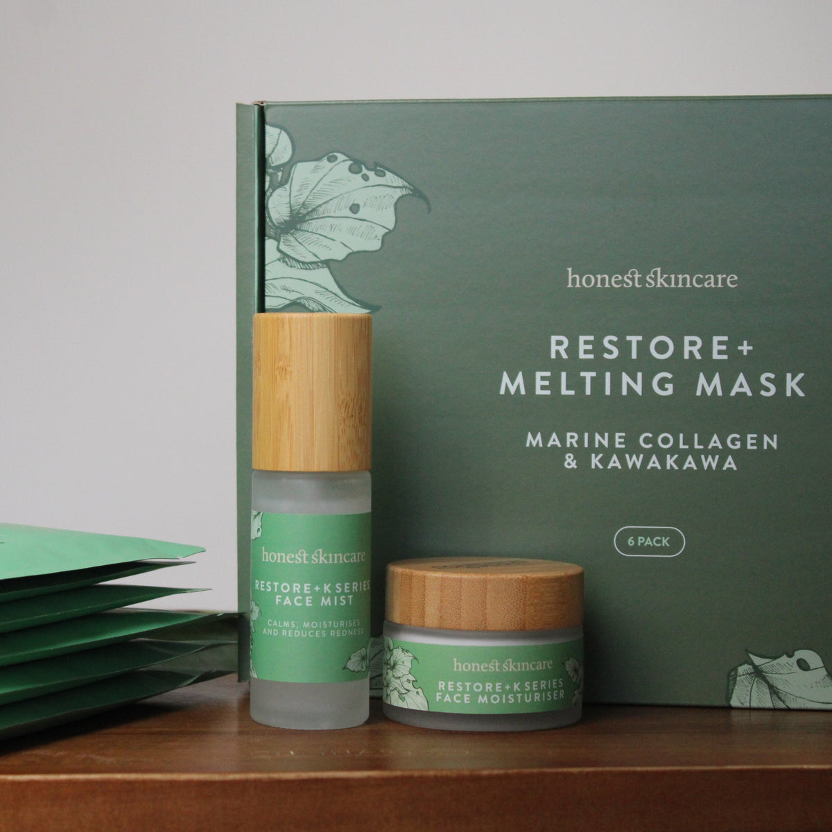 Honest Skincare products including 6 best collagen mask, face mist, moisturiser and packaging on a wooden surface. Marine collagen melting mask korean skincare