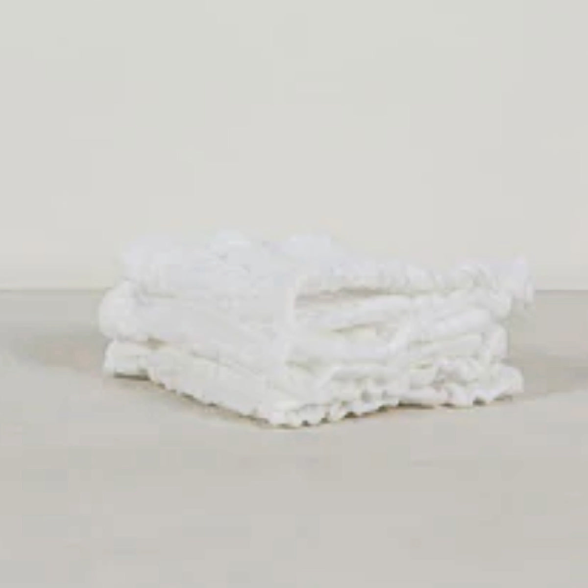 Stack of three soft muslin wash cloths by Sweet William, ideal for castor oil packs.