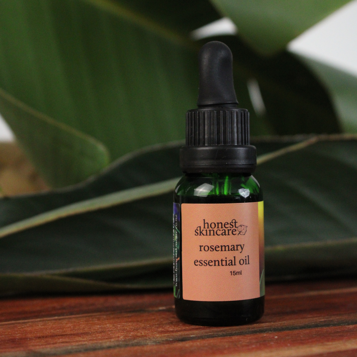 Bottle of rosemary essential oil by Honest Skincare highlighting rosemary essential oil benefits, 15ml size.