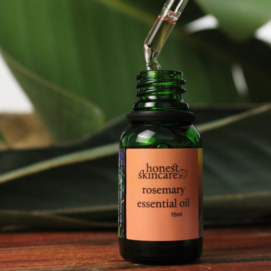 rosemary essential oil benefits in a dark glass bottle with a dropper for skincare use
