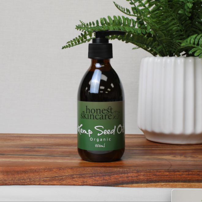 Cold pressed hemp seed oil in a brown glass bottle with pump, labeled organic skincare product.