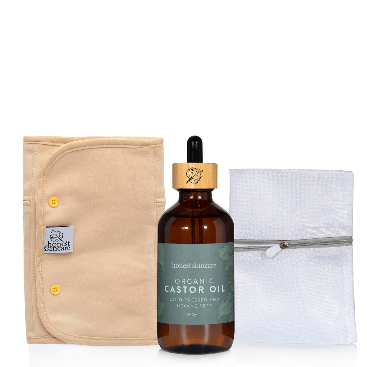 Organic castor oil bottle with a dropper, beige pouch, and white cloth on a wash bag background