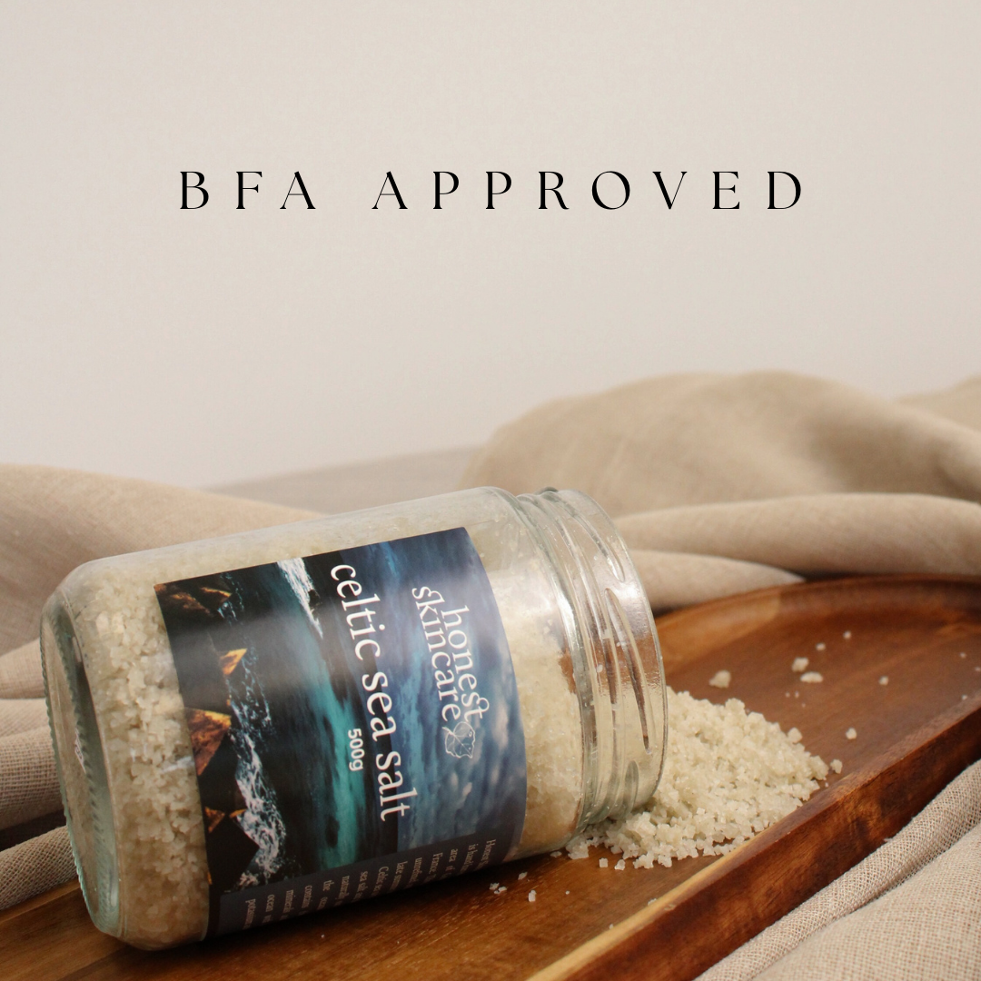 Jar of Celtic Sea Salt on a wooden board with a blurred background
