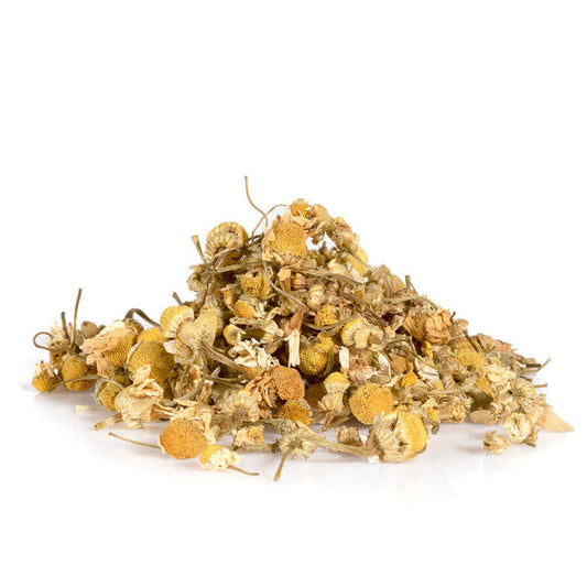 Organic chamomile flowers piled together, showcasing premium grade whole blossoms certified by BioGro.