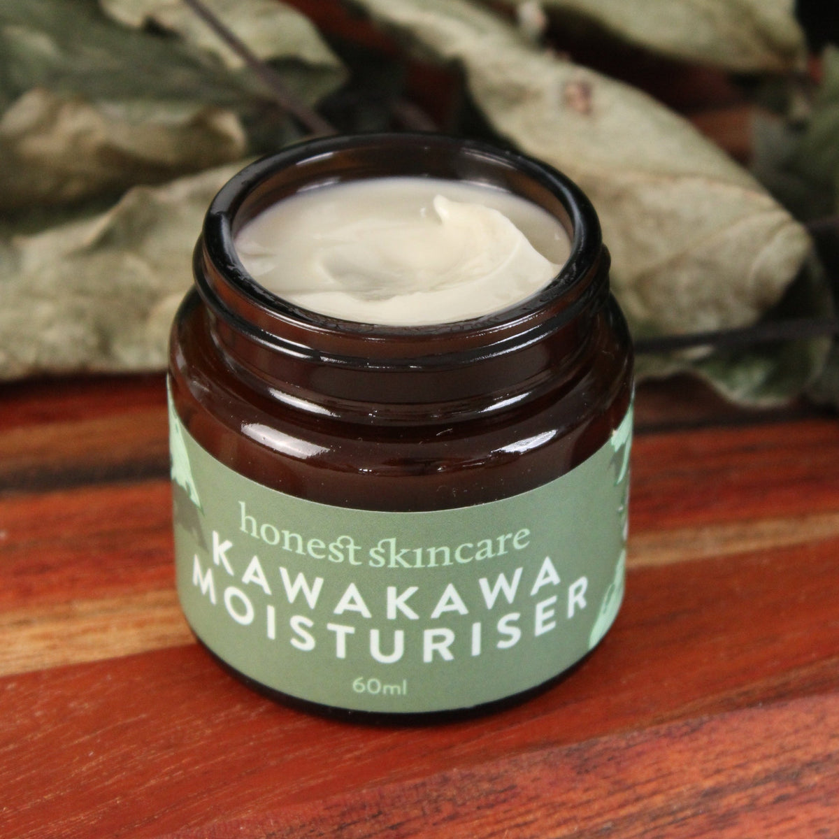 kawakawa moisturiser 60ml Skincare moisturizer with a plant in the background