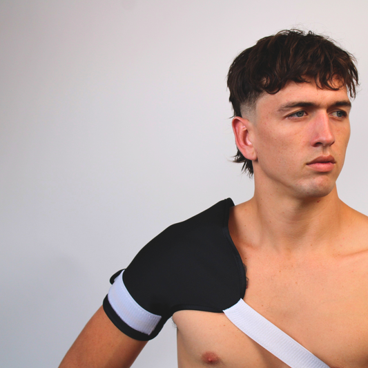 Castor oil shoulder pack being worn by a man in front of a plain background