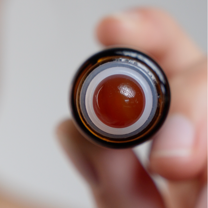 Close-up view of the Organic Castor Oil Mini Roller, showcasing the applicator tip for easy navel application.