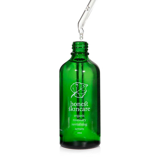 Rosemary oil for hair serum in a green glass bottle with dropper, promoting natural hair care.
