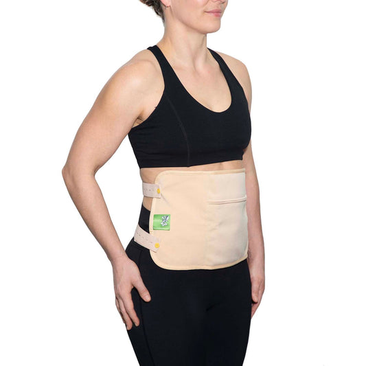 Woman wearing a Castor Oil Body Wrap for waist and back, featuring a soft organic cotton inner layer.